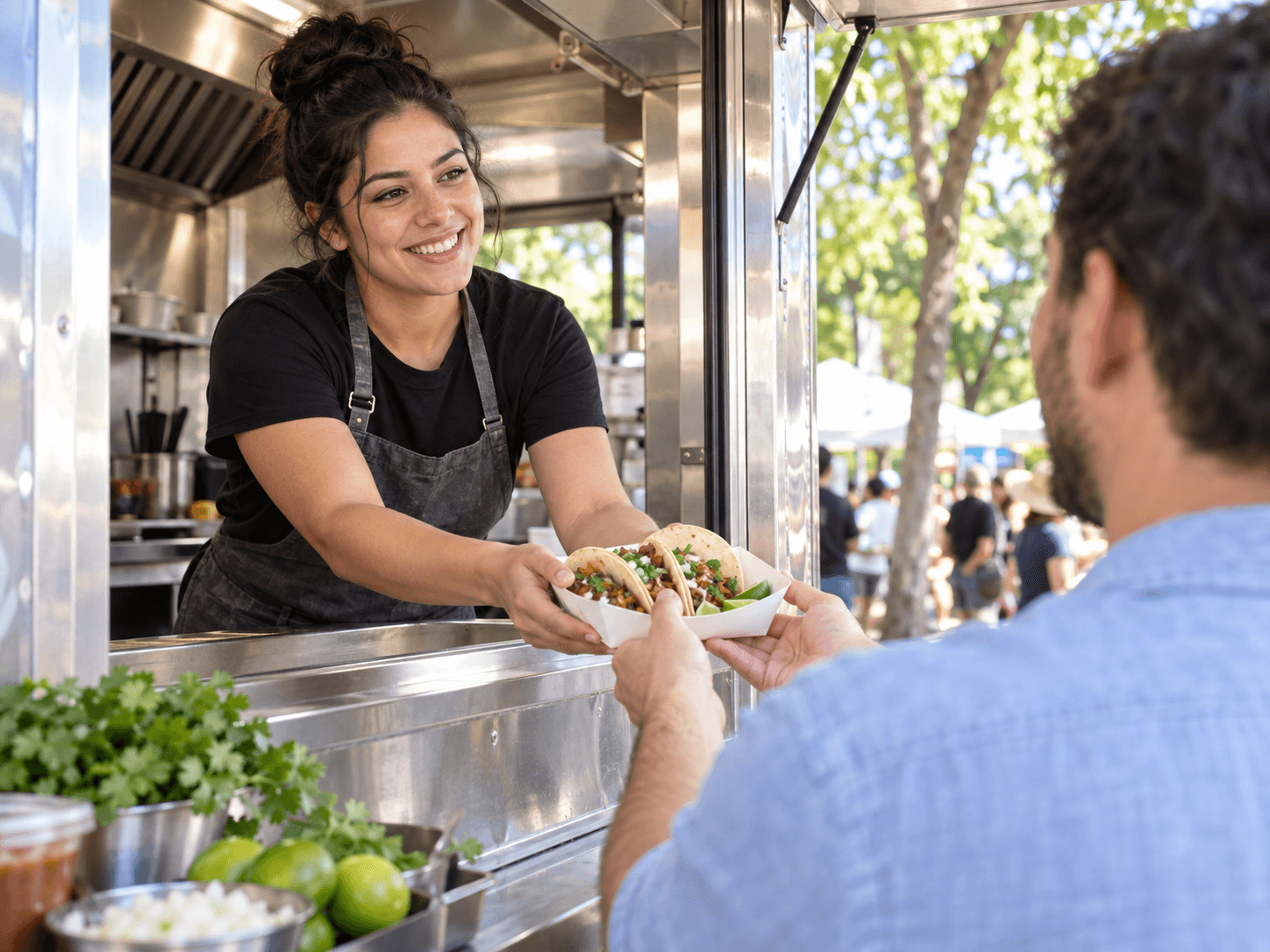 A smiling cook sharing a fresh tray of food at a neighborhood food truck